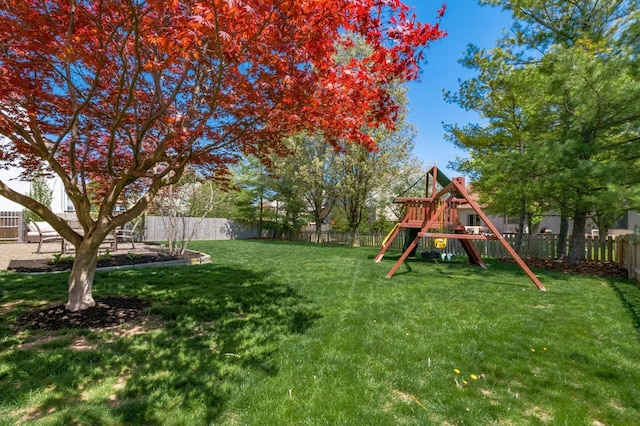 view of yard featuring a fenced backyard and a playground