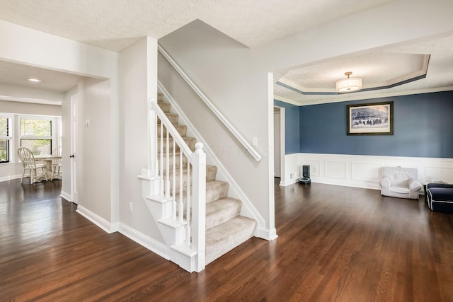 staircase with wood finished floors and baseboards