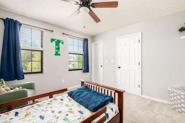 bedroom with carpet flooring, baseboards, and a ceiling fan