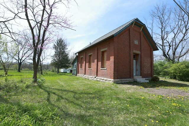2263 Amity Rd, Hilliard, OH 43026 - view of side of property with brick siding and a yard