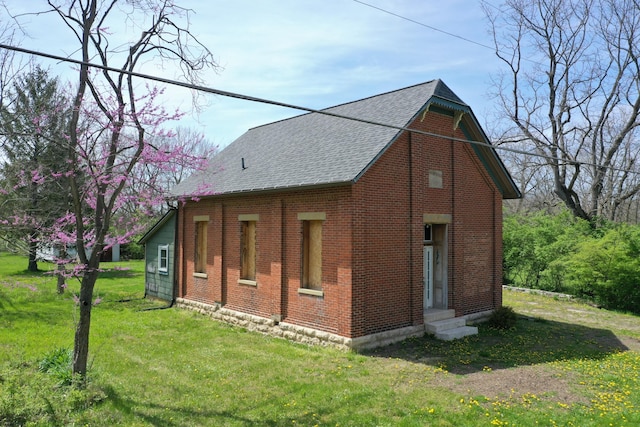 2263 Amity Rd, Hilliard, OH 43026 - view of side of property featuring a lawn, roof with shingles, and brick siding