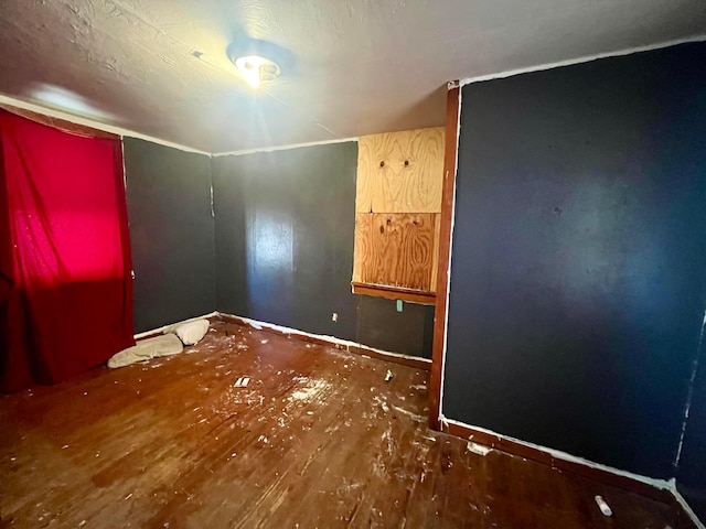empty room featuring baseboards and wood finished floors