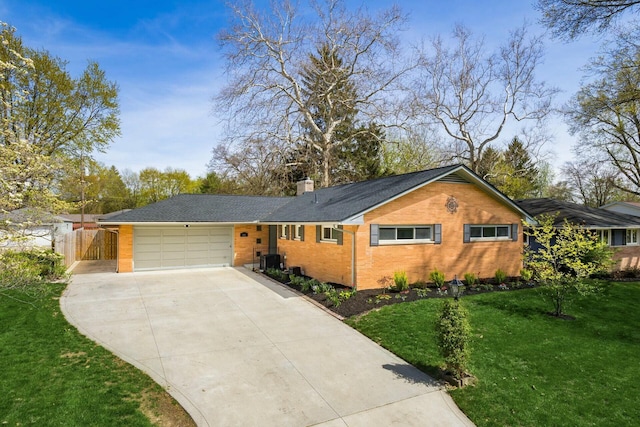 144 Serran Dr, Gahanna, OH 43230 - single story home featuring a chimney, driveway, brick siding, a front yard, and a garage