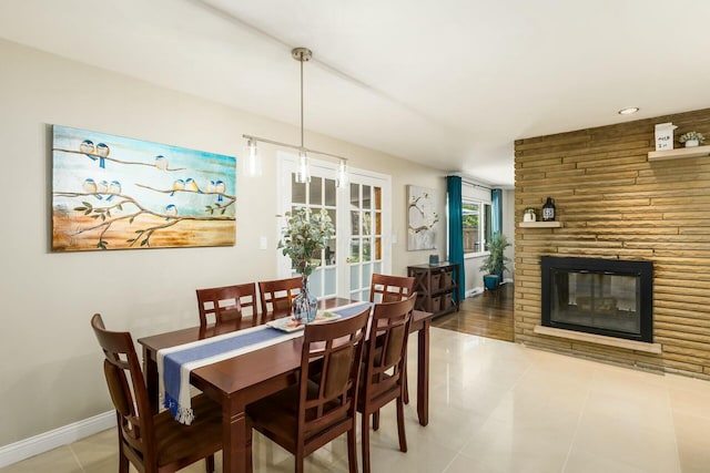 144 Serran Dr, Gahanna, OH 43230 - dining area with a large fireplace, baseboards, and light tile patterned floors