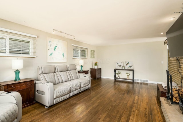 144 Serran Dr, Gahanna, OH 43230 - living room with rail lighting, baseboards, wood finished floors, and visible vents
