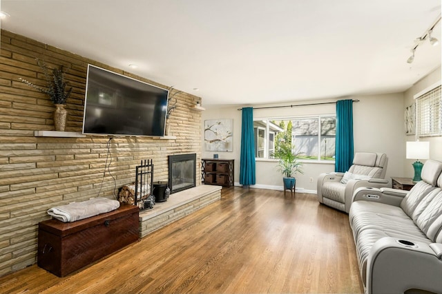 144 Serran Dr, Gahanna, OH 43230 - living area with track lighting, baseboards, wood finished floors, and a fireplace