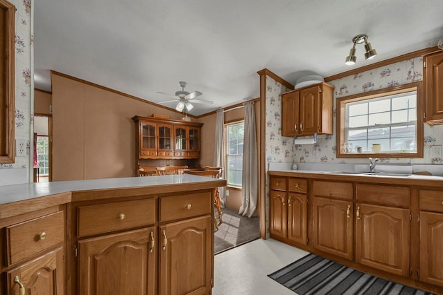 230 Norman Ln, Reynoldsburg, OH 43068 - kitchen featuring brown cabinets, wallpapered walls, a ceiling fan, ornamental molding, and a peninsula