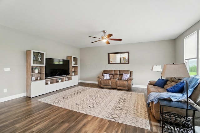 living room with a ceiling fan, wood finished floors, and baseboards