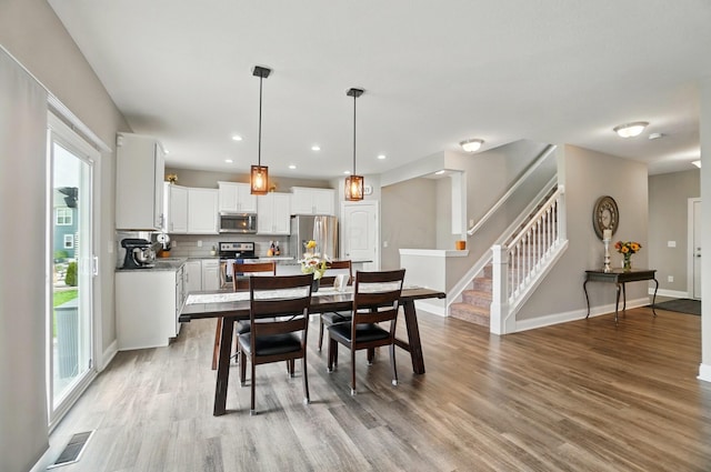 dining area with stairway, visible vents, baseboards, recessed lighting, and light wood finished floors