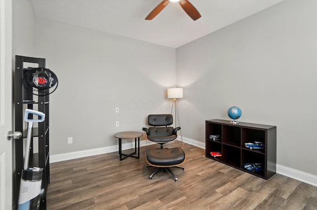 sitting room with wood finished floors, ceiling fan, and baseboards