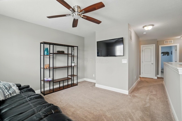 living room featuring visible vents, baseboards, a ceiling fan, and light carpet