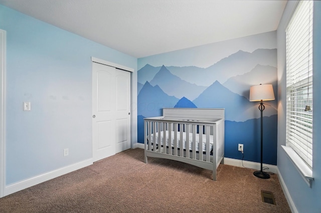 carpeted bedroom with visible vents, multiple windows, and baseboards