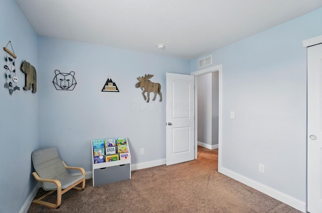 sitting room with carpet, visible vents, and baseboards