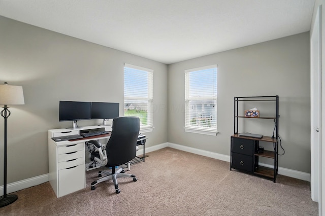 office area with light colored carpet and baseboards