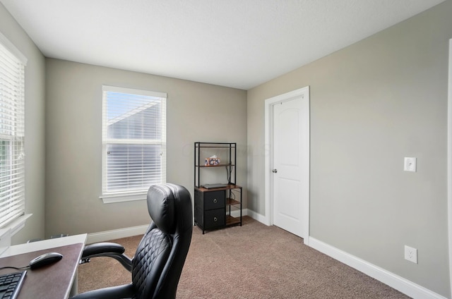 home office featuring light colored carpet and baseboards
