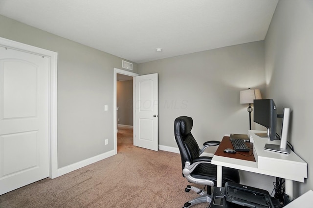 carpeted home office with baseboards and visible vents