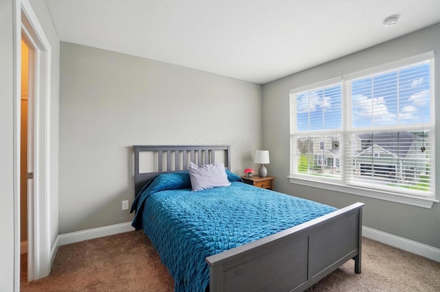 carpeted bedroom with baseboards