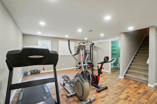 exercise room featuring visible vents, recessed lighting, light wood finished floors, and baseboards
