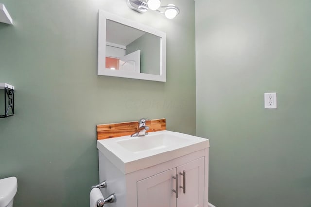 half bathroom with toilet and vanity