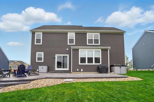 back of house with a patio and a lawn
