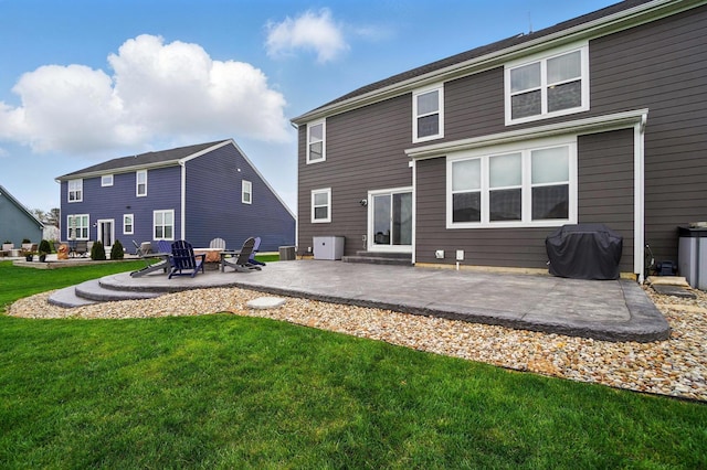 rear view of property with a patio, central AC, and a lawn
