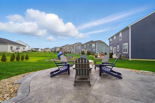 view of patio with a fire pit, central AC, and a residential view