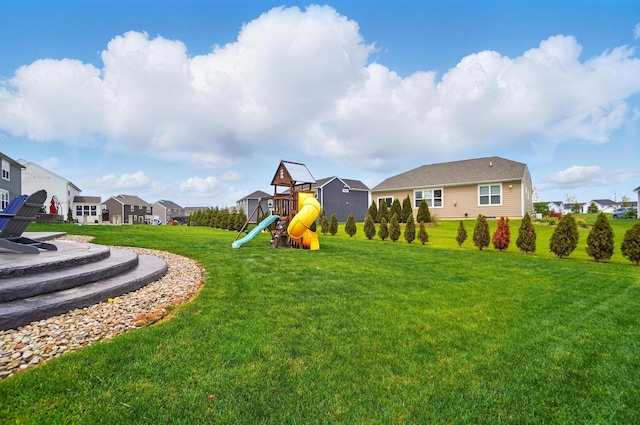 view of playground featuring a residential view and a yard