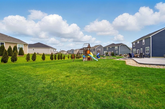 view of yard with a residential view, a playground, and a patio area
