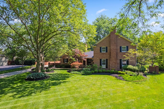 4318 Lyon Dr, Upper Arlington, OH 43220 - view of front of house with a front lawn, a chimney, and brick siding