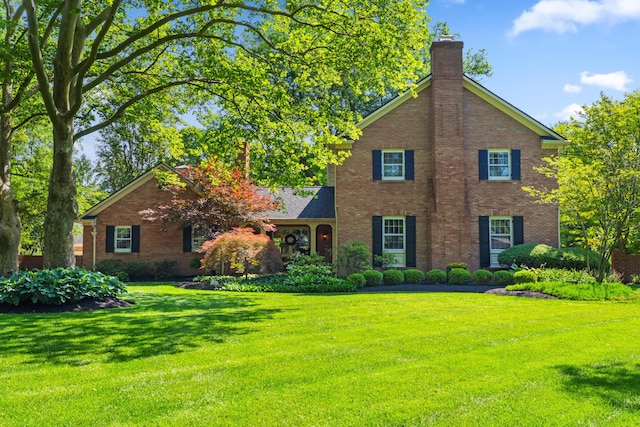 4318 Lyon Dr, Upper Arlington, OH 43220 - view of front of property with brick siding, a chimney, and a front yard