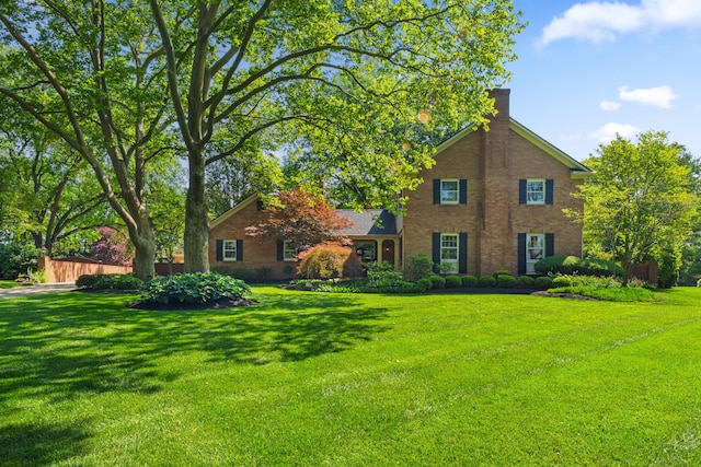 4318 Lyon Dr, Upper Arlington, OH 43220 - view of front of property with a front lawn, brick siding, and a chimney