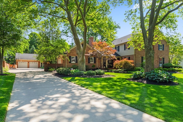 4318 Lyon Dr, Upper Arlington, OH 43220 - view of front of property featuring brick siding, a chimney, a front yard, and a garage