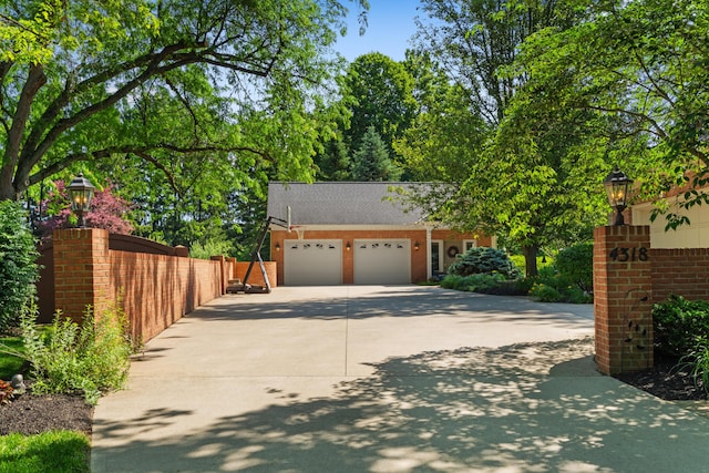 4318 Lyon Dr, Upper Arlington, OH 43220 - view of front of property featuring a garage, driveway, a shingled roof, and brick siding