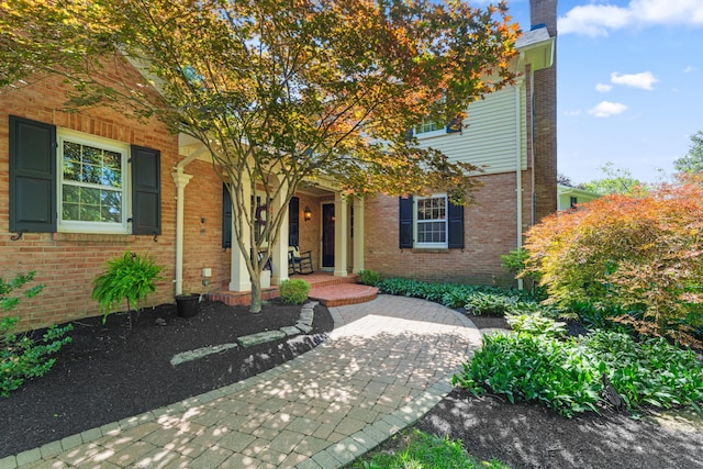 4318 Lyon Dr, Upper Arlington, OH 43220 - view of front of house featuring a porch, brick siding, and a chimney