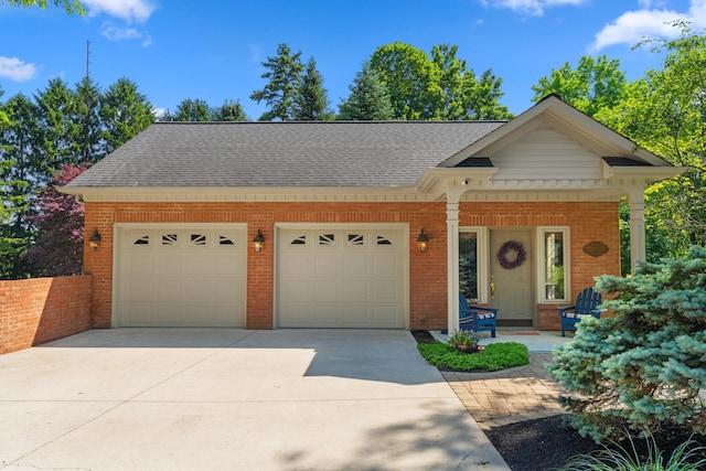4318 Lyon Dr, Upper Arlington, OH 43220 - view of front of property with brick siding, an attached garage, concrete driveway, and roof with shingles
