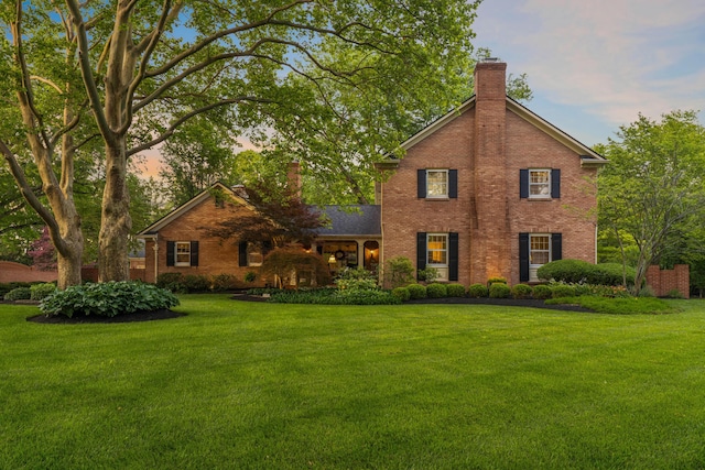 4318 Lyon Dr, Upper Arlington, OH 43220 - view of front of home featuring a chimney, brick siding, and a front yard