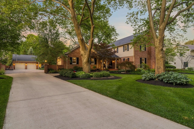 4318 Lyon Dr, Upper Arlington, OH 43220 - view of front of home featuring an outdoor structure, brick siding, concrete driveway, a lawn, and a garage