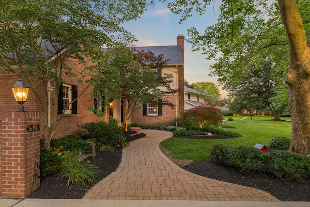 4318 Lyon Dr, Upper Arlington, OH 43220 - view of front of property featuring a chimney, brick siding, and a lawn