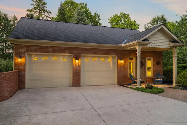 4318 Lyon Dr, Upper Arlington, OH 43220 - view of front of home with concrete driveway, brick siding, a garage, and a shingled roof