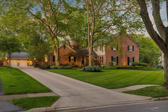 4318 Lyon Dr, Upper Arlington, OH 43220 - view of front of house featuring brick siding, concrete driveway, and a front lawn