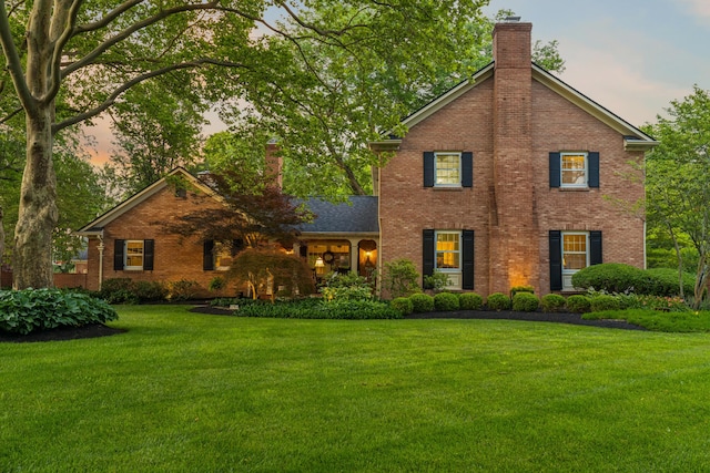 4318 Lyon Dr, Upper Arlington, OH 43220 - traditional-style home featuring a chimney, brick siding, and a front yard