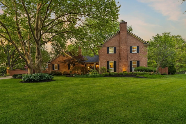 4318 Lyon Dr, Upper Arlington, OH 43220 - traditional-style house featuring a chimney, brick siding, and a yard