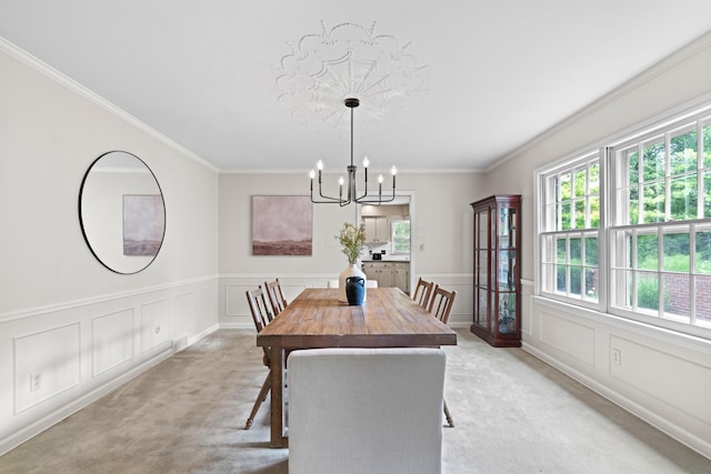 4318 Lyon Dr, Upper Arlington, OH 43220 - dining room featuring light colored carpet, healthy amount of natural light, a chandelier, a decorative wall, and crown molding