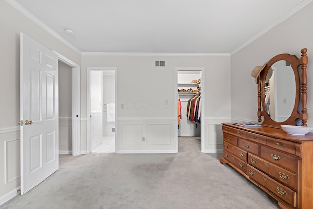 4318 Lyon Dr, Upper Arlington, OH 43220 - bedroom featuring a walk in closet, ornamental molding, light carpet, a closet, and wainscoting