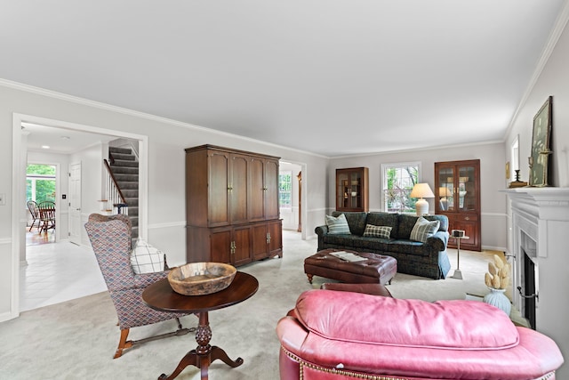 4318 Lyon Dr, Upper Arlington, OH 43220 - living room featuring stairs, light colored carpet, crown molding, plenty of natural light, and a fireplace