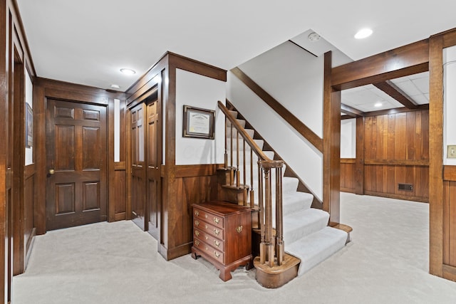 4318 Lyon Dr, Upper Arlington, OH 43220 - carpeted foyer entrance featuring wood walls, stairs, recessed lighting, and a wainscoted wall