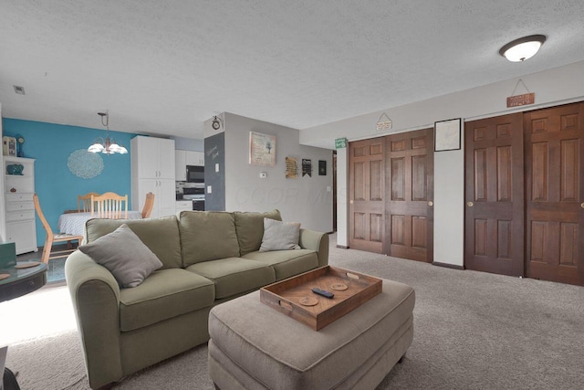 625 Country Club Dr Unit B14, Newark, OH 43055 - living room with an inviting chandelier, carpet, visible vents, and a textured ceiling