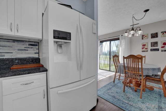 625 Country Club Dr Unit B14, Newark, OH 43055 - kitchen featuring a chandelier, tasteful backsplash, white fridge with ice dispenser, dark countertops, and white cabinets