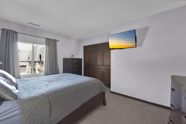625 Country Club Dr Unit B14, Newark, OH 43055 - bedroom with carpet, visible vents, a textured ceiling, and baseboards