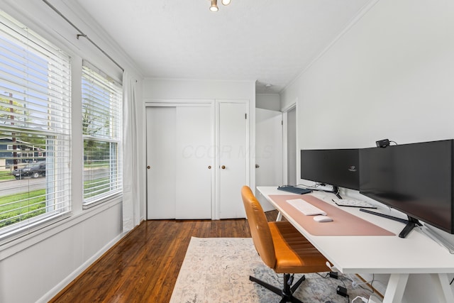 home office featuring plenty of natural light, crown molding, and dark wood-style floors